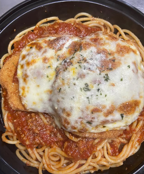 A close up of a plate of spaghetti with meat sauce and a fork.