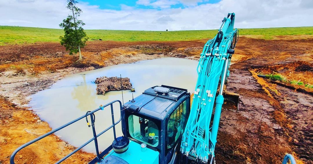 Excavator Extracting and Loading Gravel — Civil Contractors in Coopernook, NSW