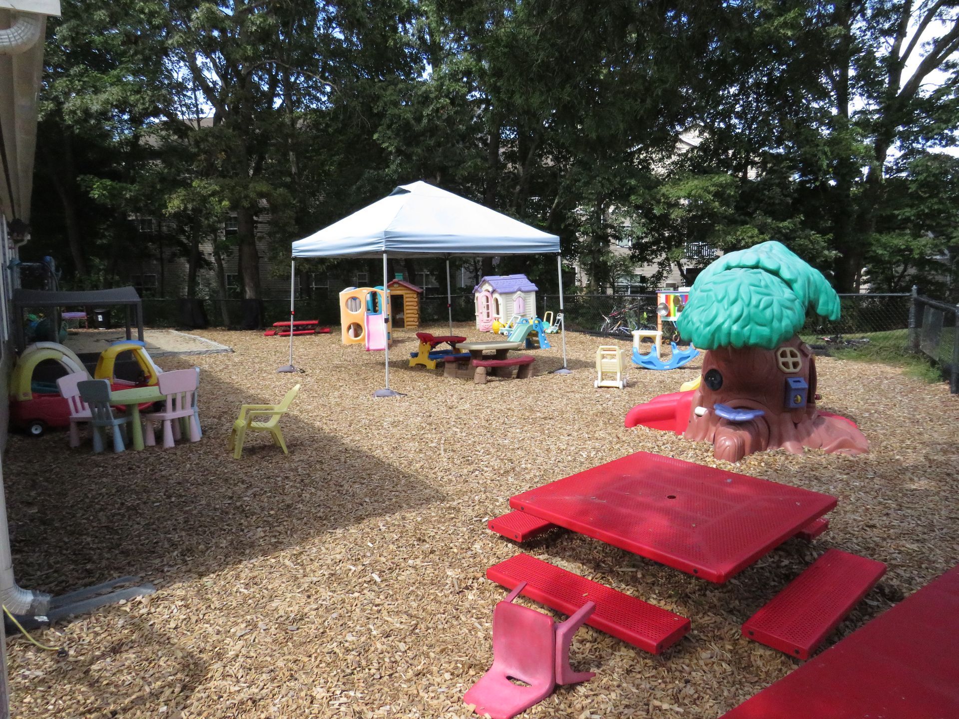 There is a sandbox in the middle of a playground.