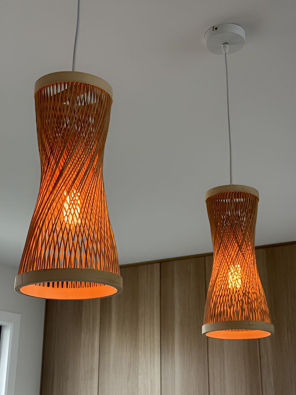 Two Wicker Pendant Lights Are Hanging From the Ceiling — Tec Electrical & Air In Rothwell, QLD