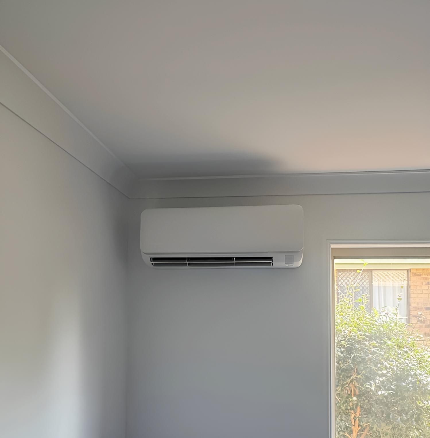 A Room With a Window and a Wall Mounted Air Conditioner — Tec Electrical & Air In Caboolture, QLD