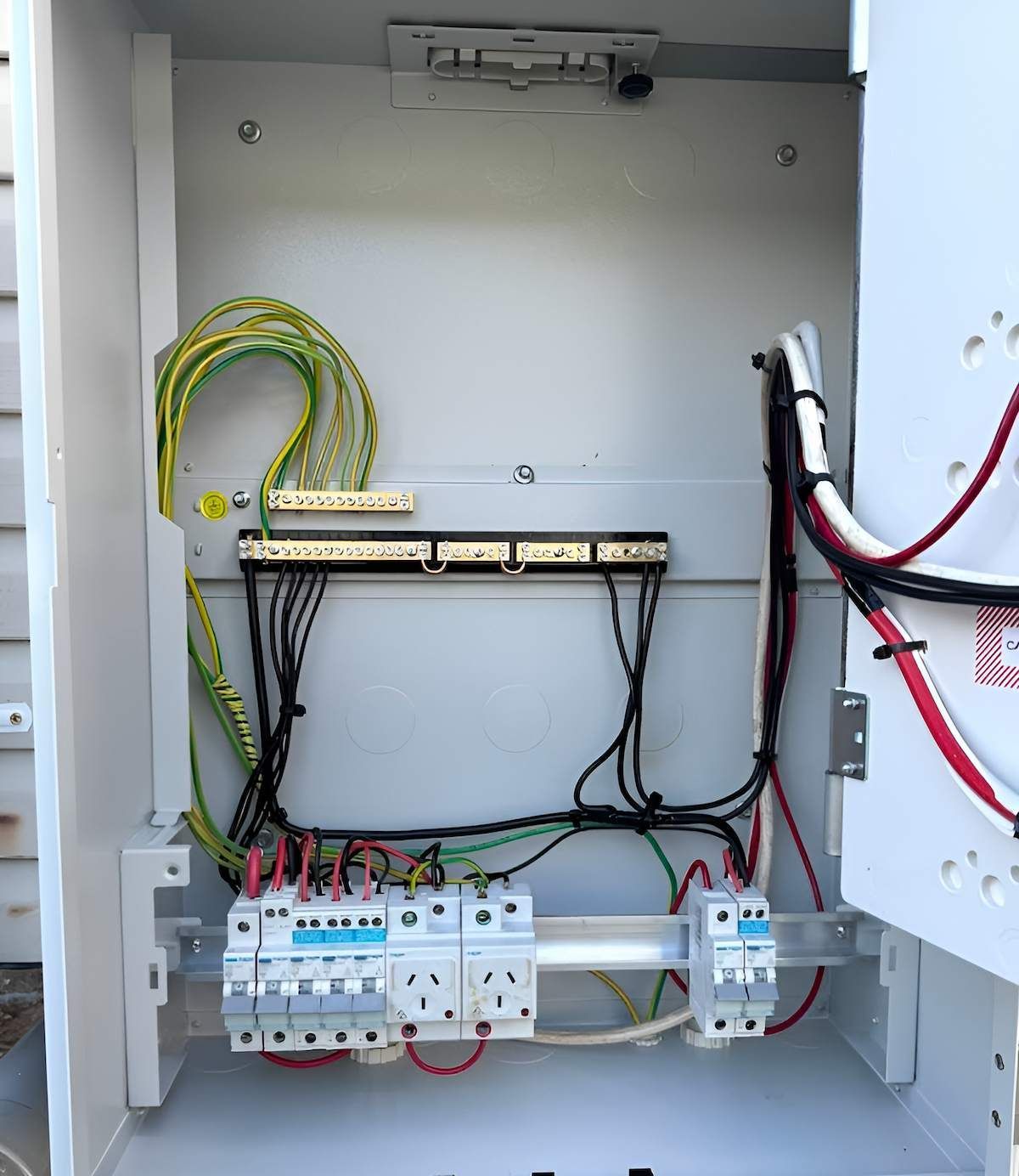 A White Box With a Bunch of Wires in It — Tec Electrical & Air In Rothwell, QLD