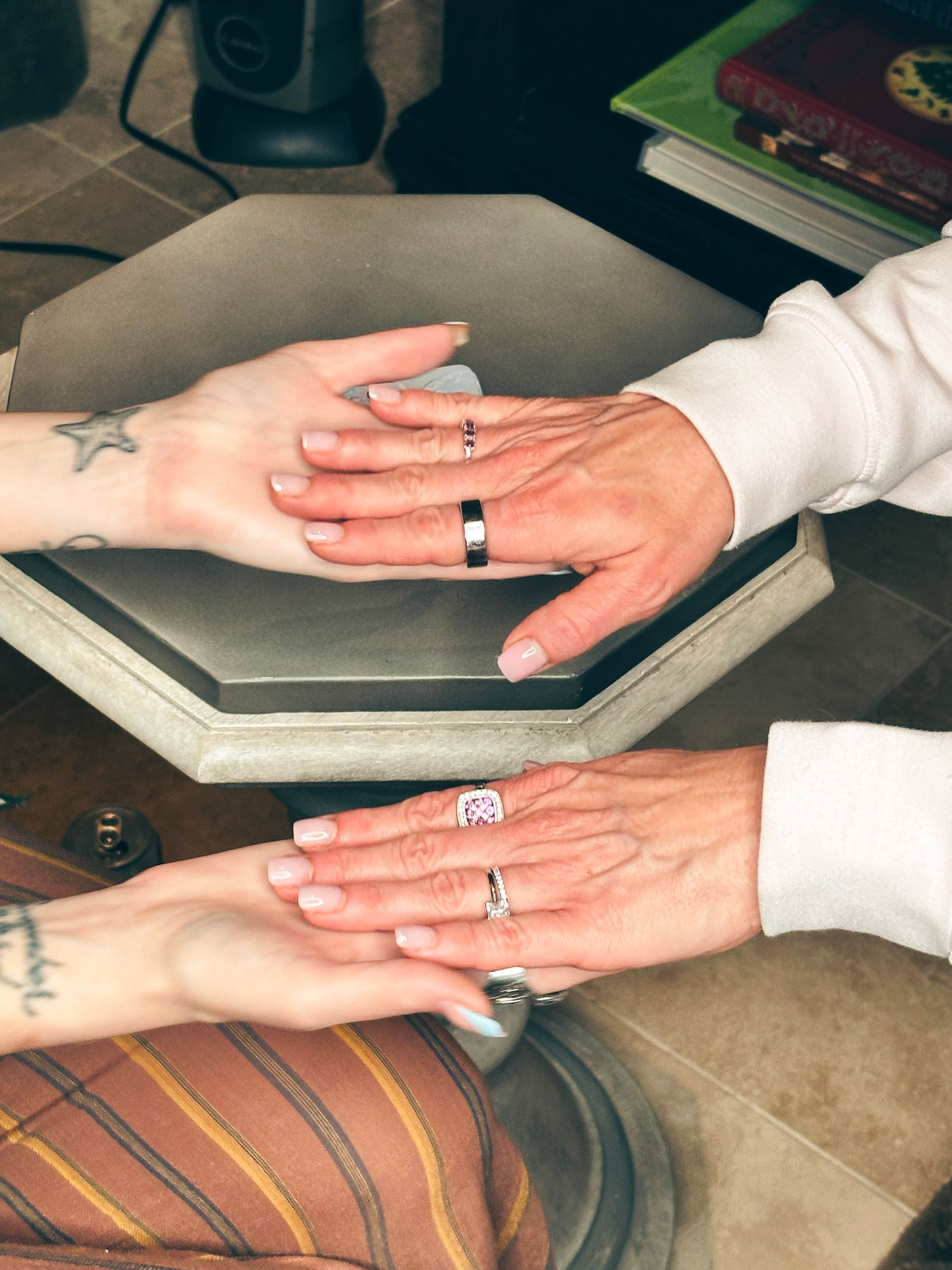 A man and a woman holding hands with rings on their fingers