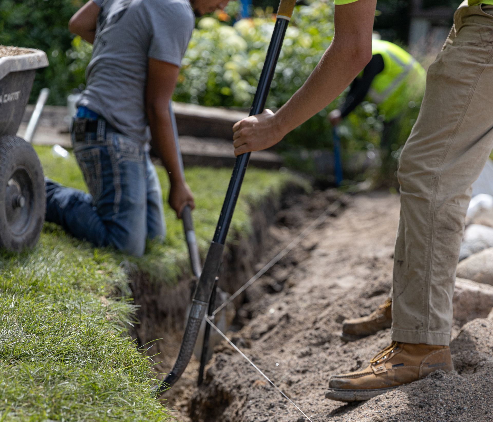 A man is using a shovel to dig a hole in the ground.