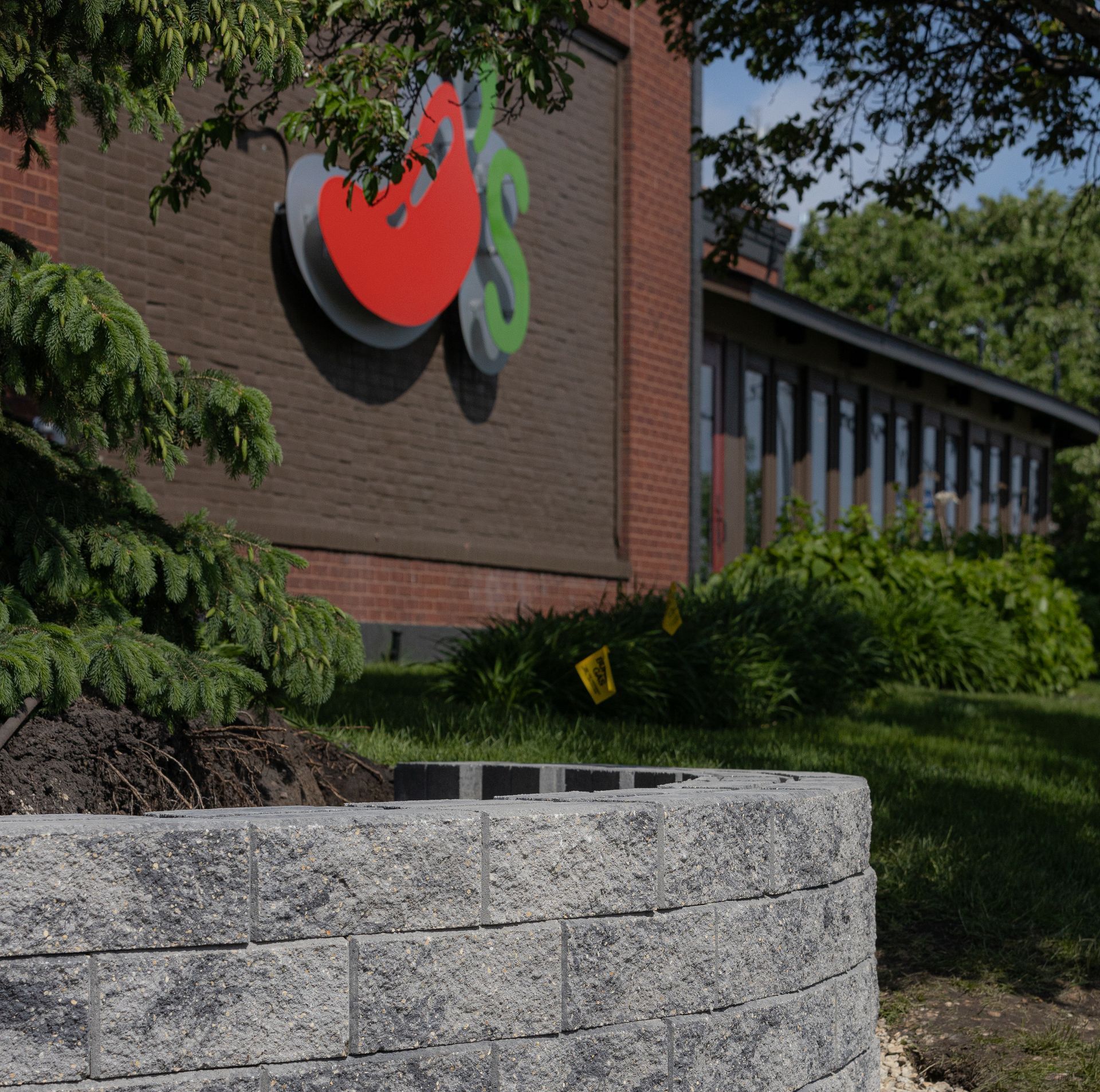 There is a park in the foreground and a city skyline in the background.