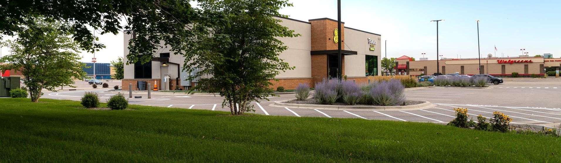 A large building with a parking lot in front of it.