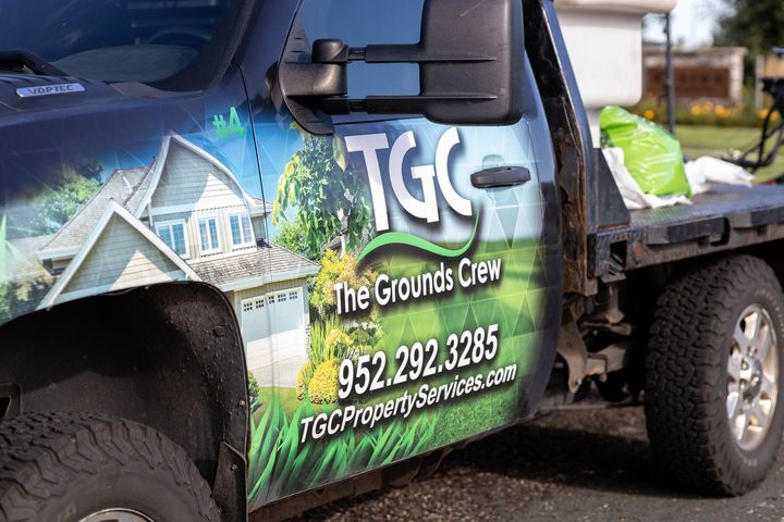 A truck with the grounds crew written on the side