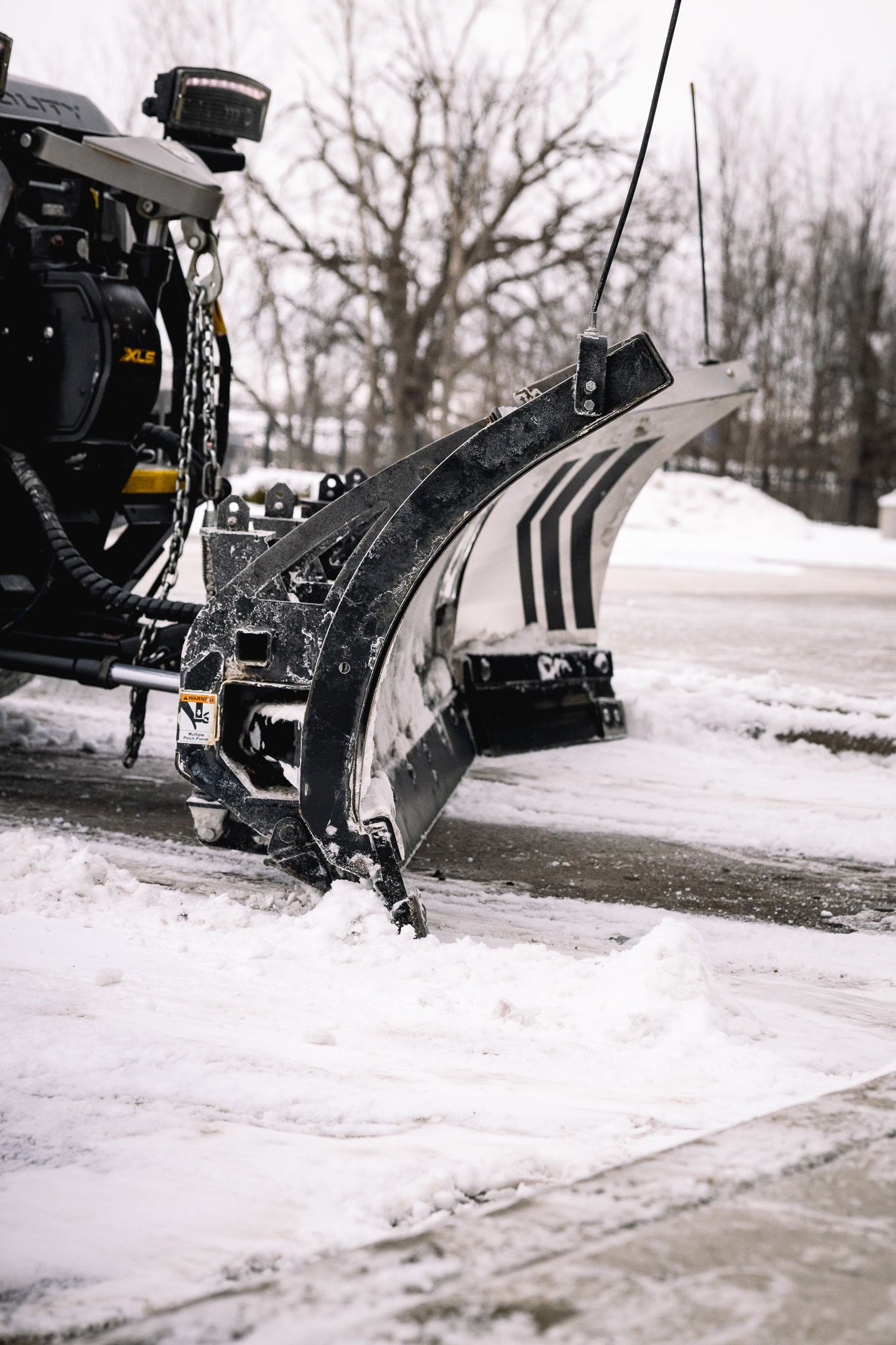 a tgc snow plowing truck is parked in front of a building