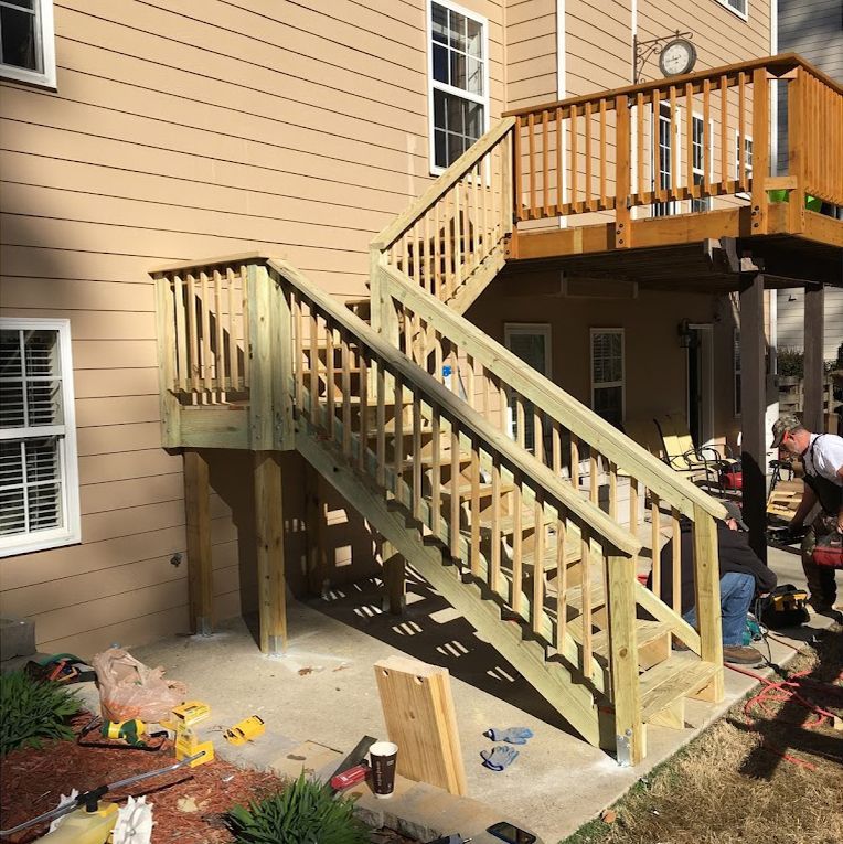 A wooden deck with stairs leading up to it