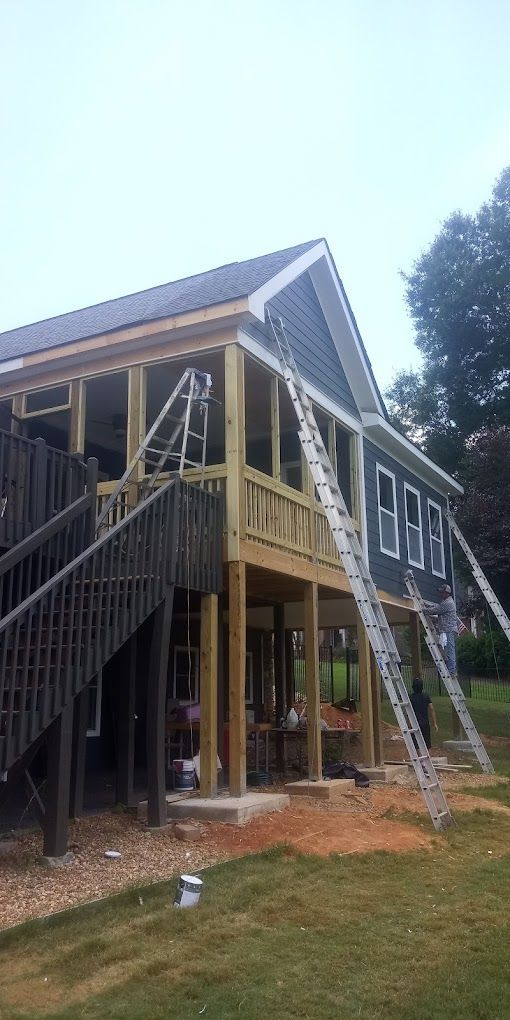 A house is being built with a ladder attached to the side of it