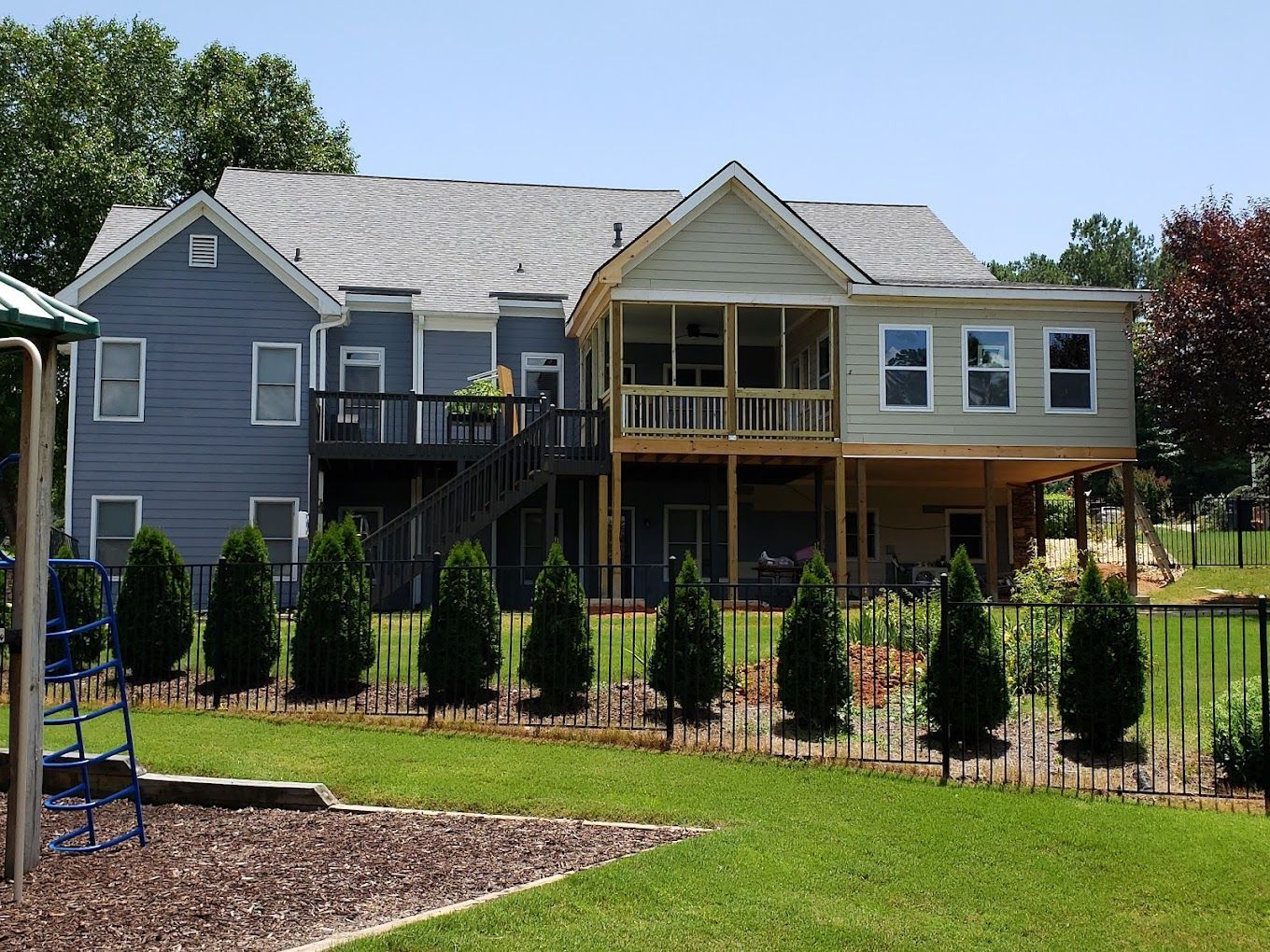 A large house with a playground in front of it
