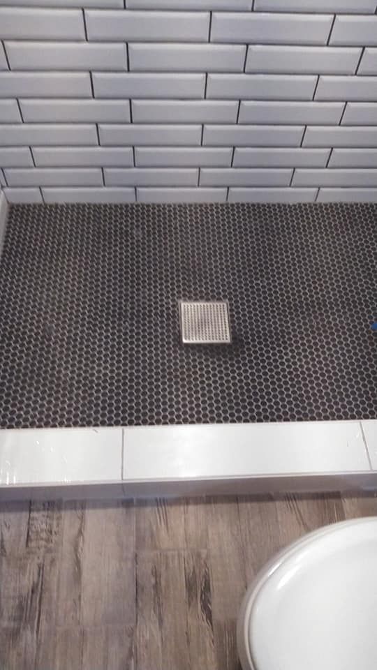 A bathroom with a walk in shower and a bathtub