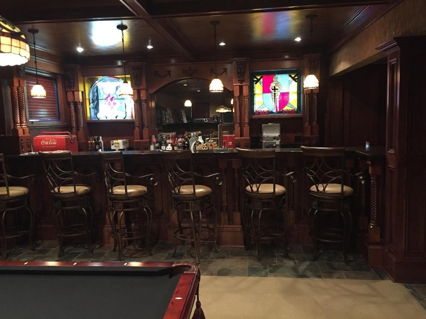 A pool table is in the middle of a bar