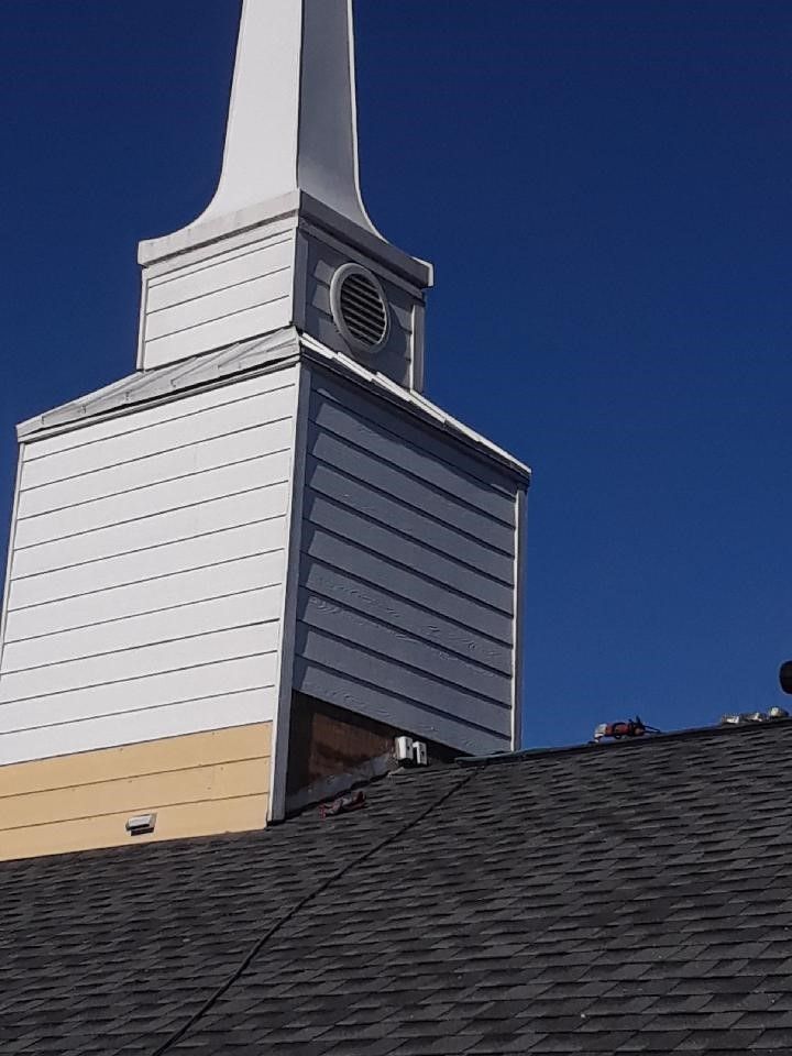 A church steeple with a clock on top of it