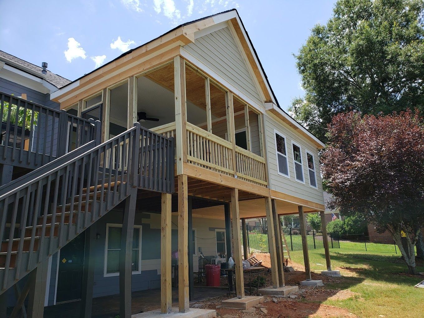 A house is being built on stilts with a deck and stairs