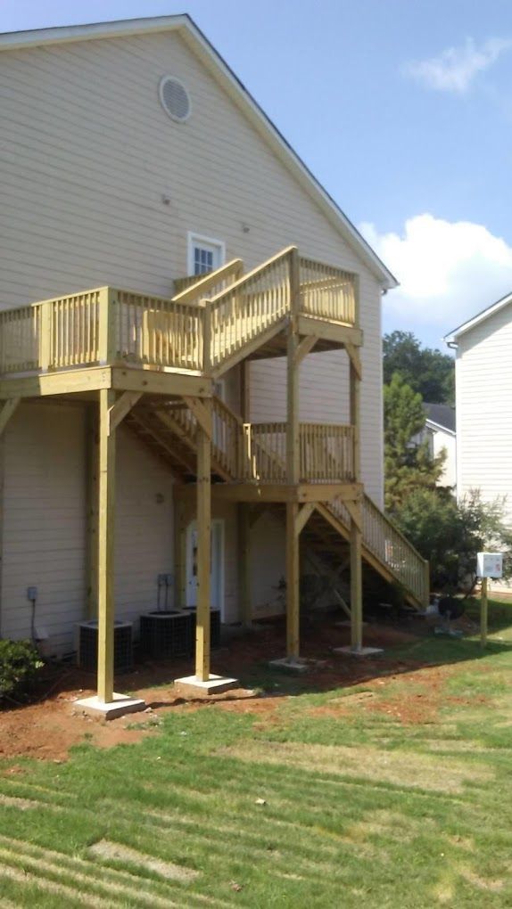 A house with a wooden deck and stairs on the side