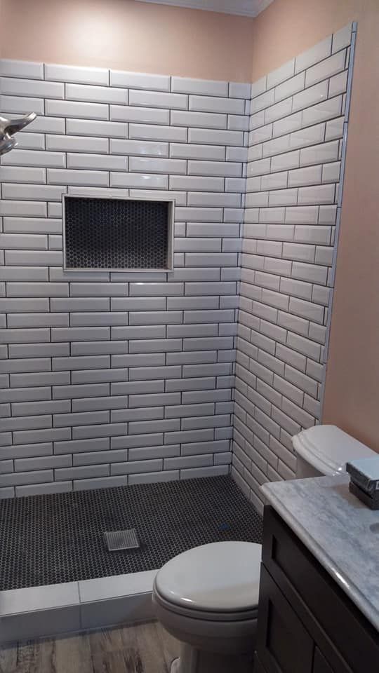 A bathroom with brick wall