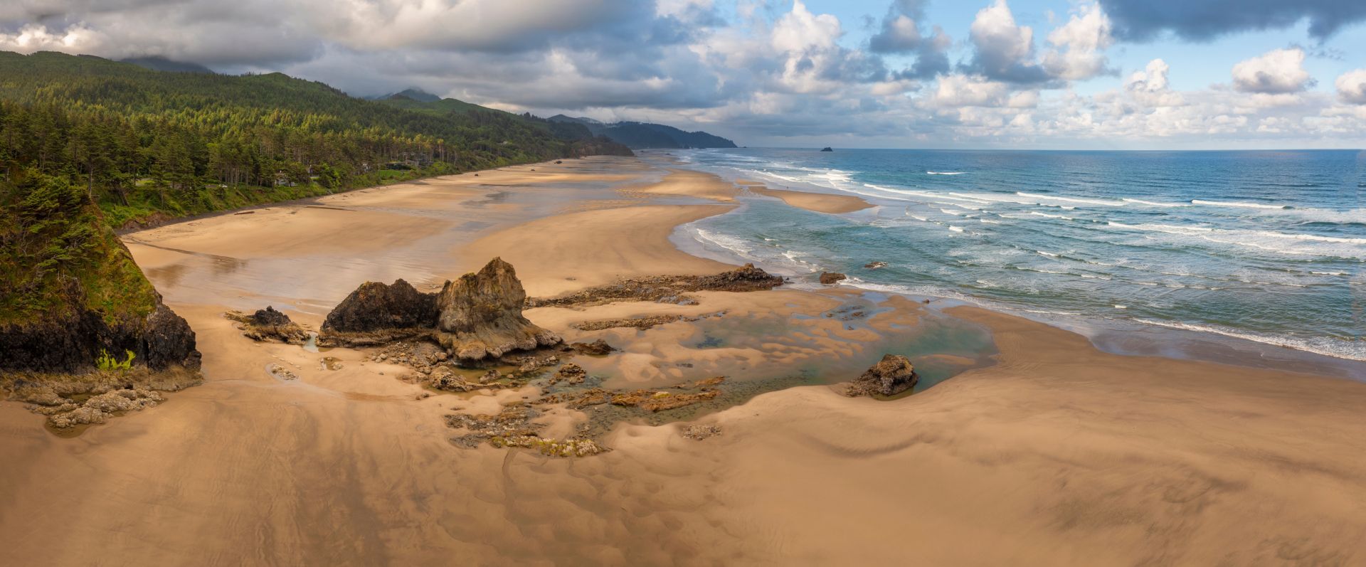 An aerial view of a sandy beach next to the ocean.