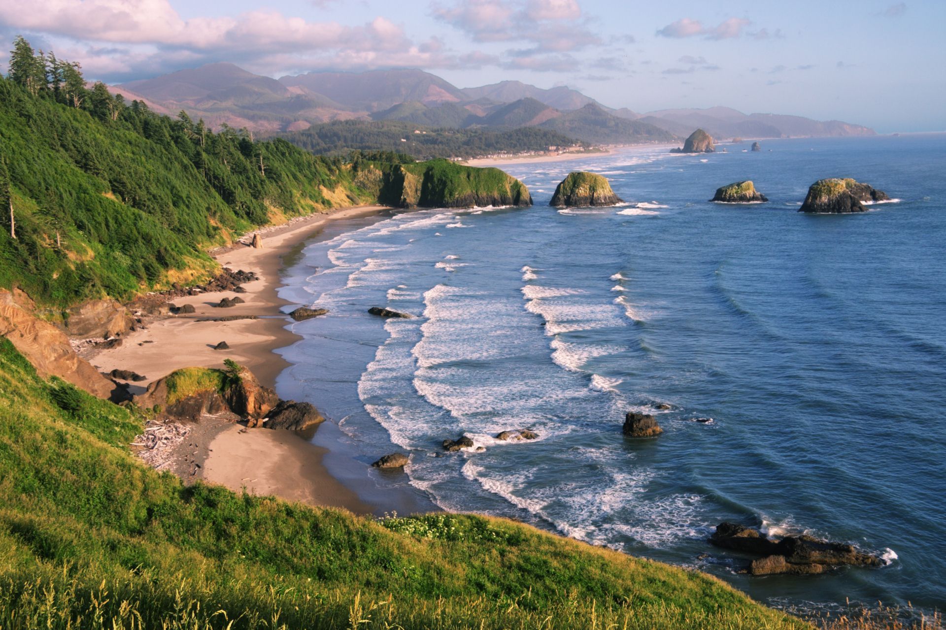 A view of a beach with mountains in the background