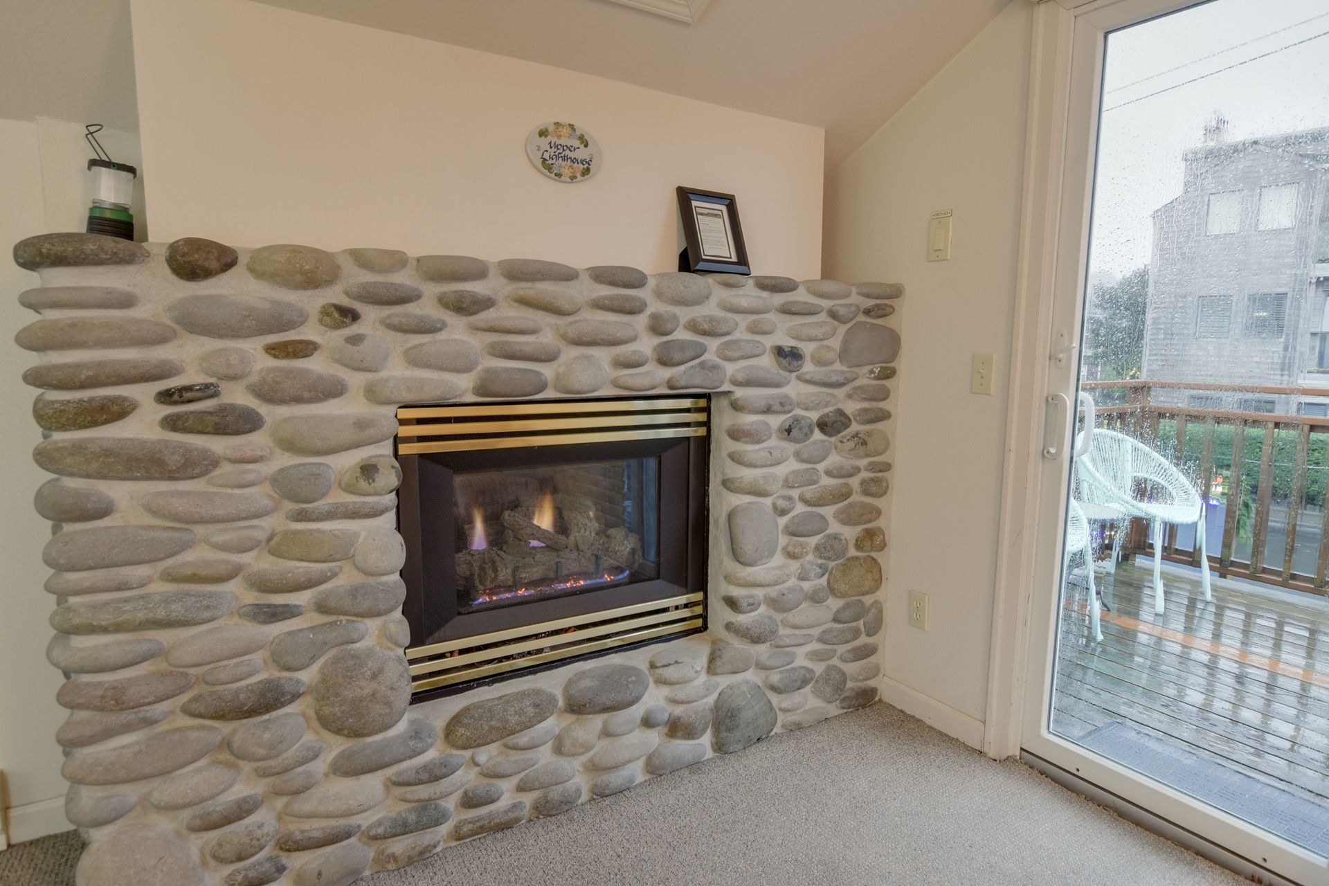 A living room with a fireplace and a clock on the wall