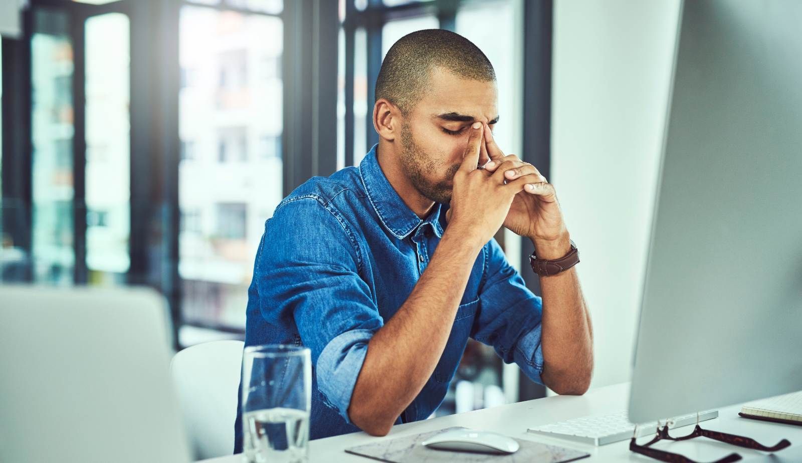 Burned‑out office worker swapping a suit jacket for a Mastertech Environmental polo.