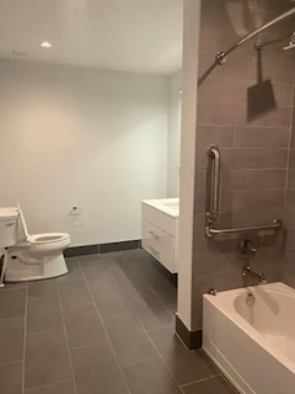 A bathroom with a toilet , sink , and bathtub.