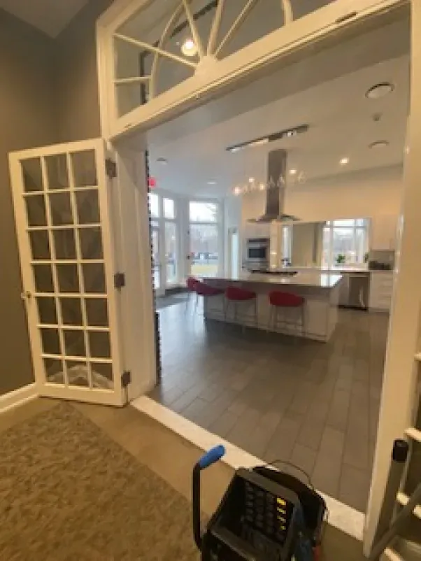 A kitchen with a large island and stainless steel appliances