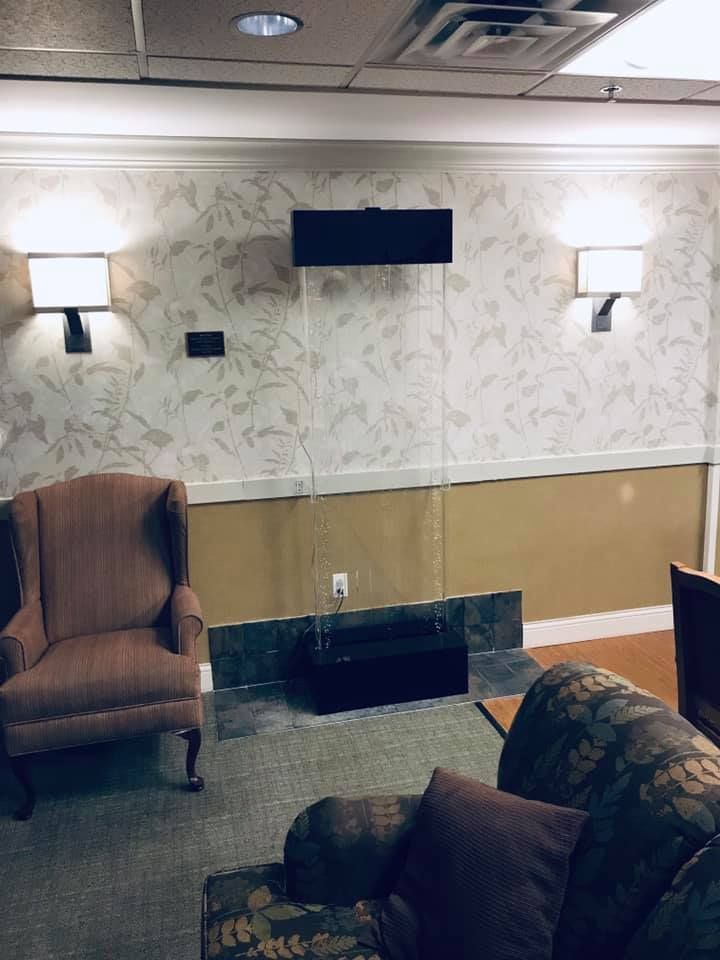 A living room with a couch , chair and television