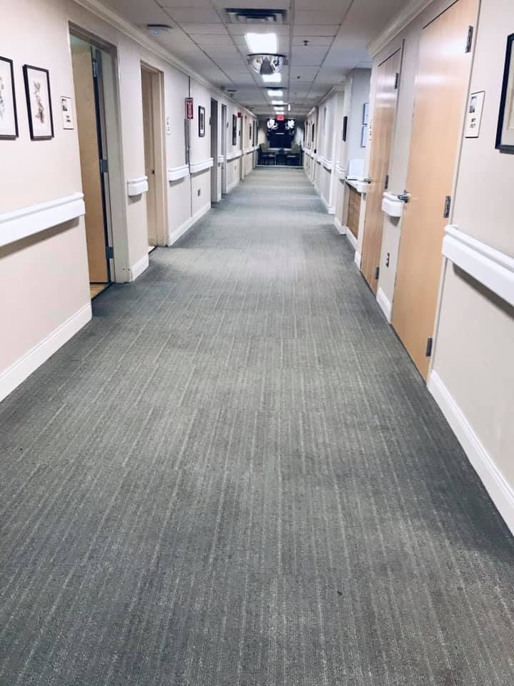 A long hallway in a hospital with a lot of doors