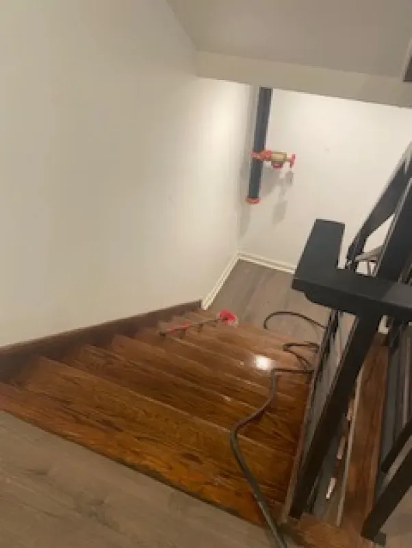 A set of wooden stairs leading up to the second floor of a house.