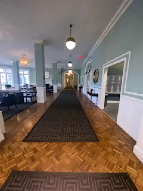 A long hallway with a rug on the floor