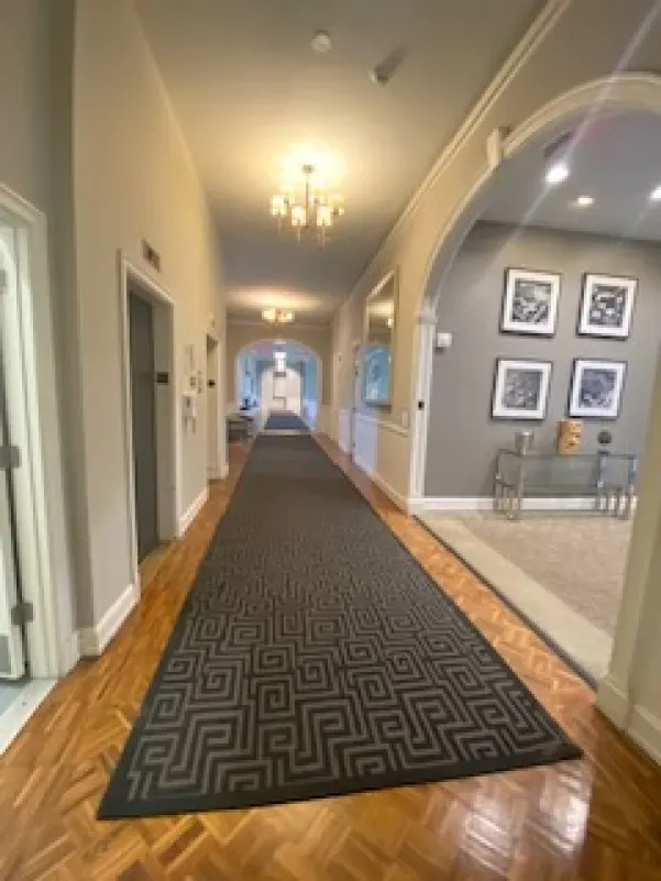 A long hallway with a rug on the floor