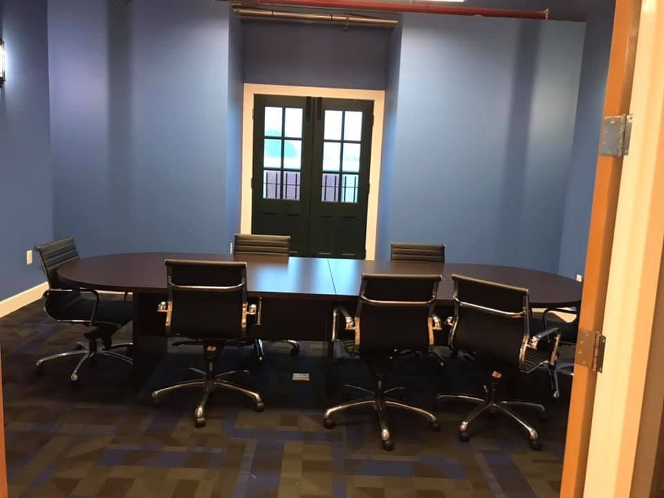 A conference room with a long table and chairs