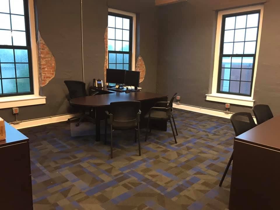 A conference room with a round table and chairs