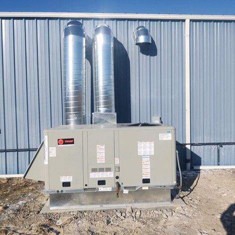 Two air conditioners are sitting outside of a building
