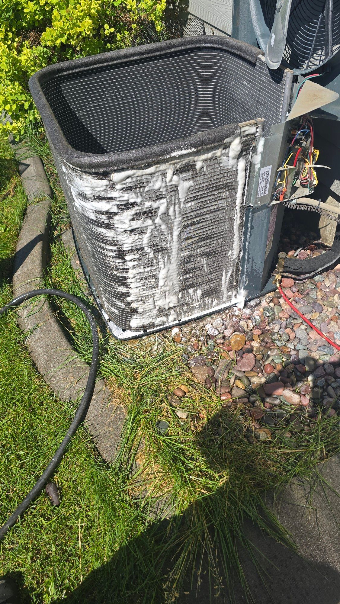A man is working on an air conditioner in a room.