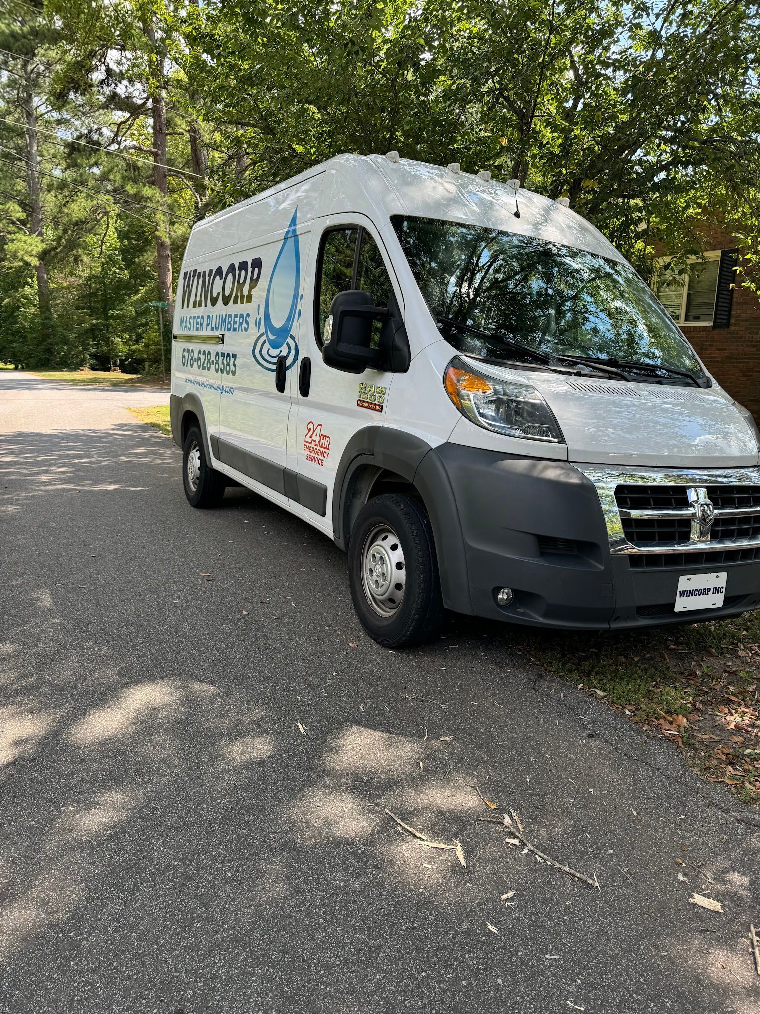 A white van is parked on the side of the road.