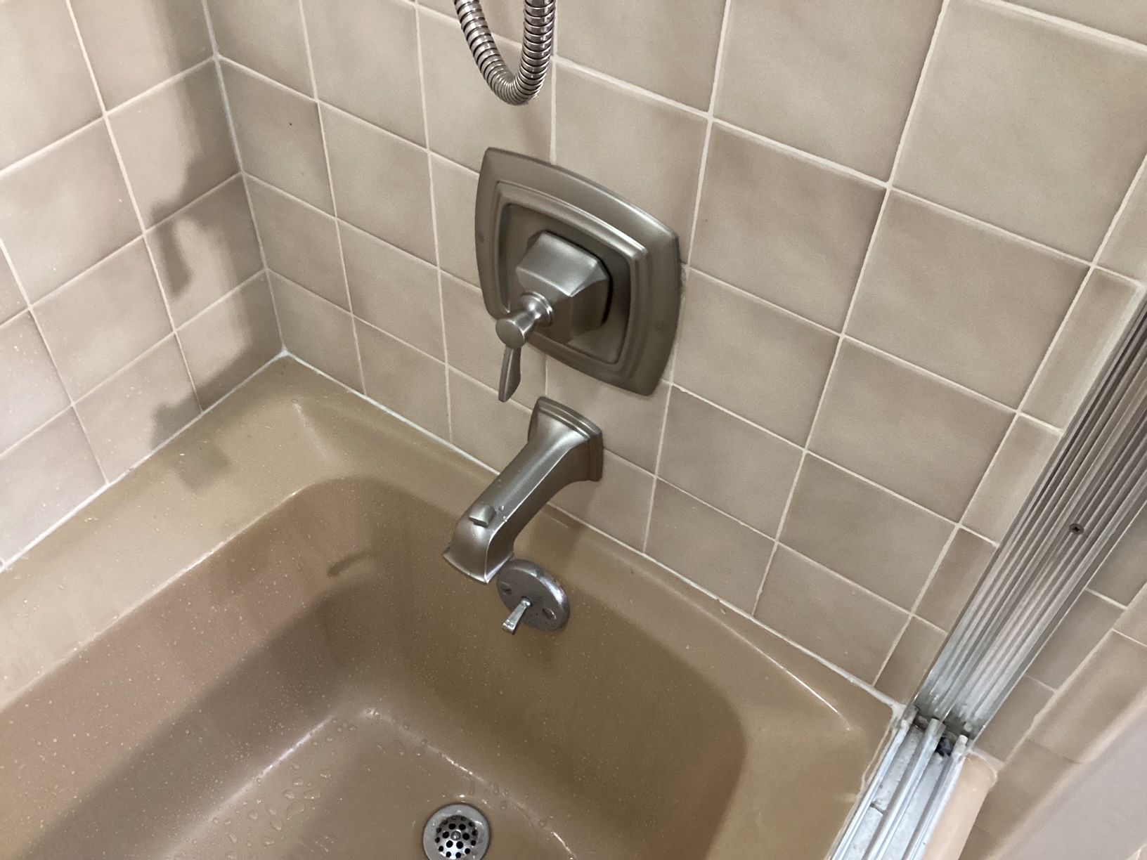 A bathtub with a faucet and shower head in a bathroom.