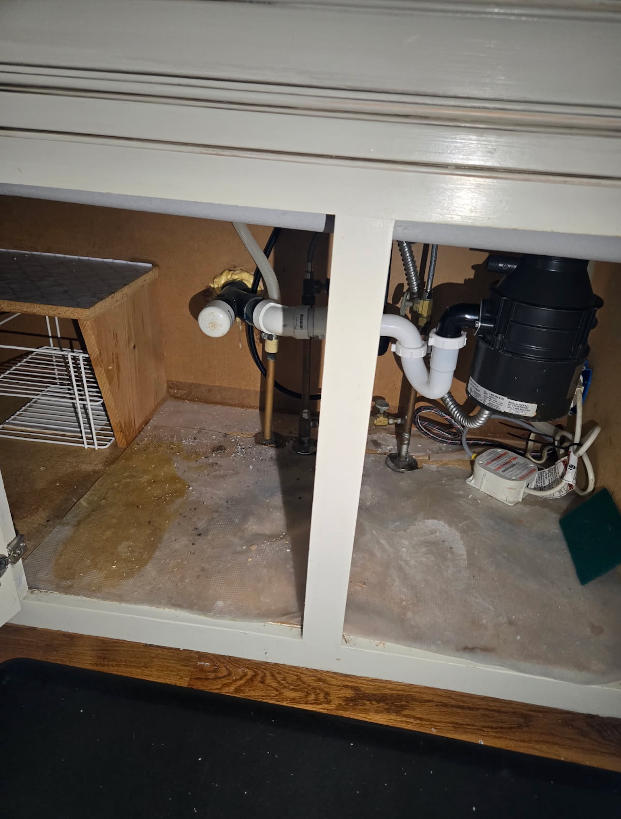 A kitchen sink with a garbage disposal underneath it.