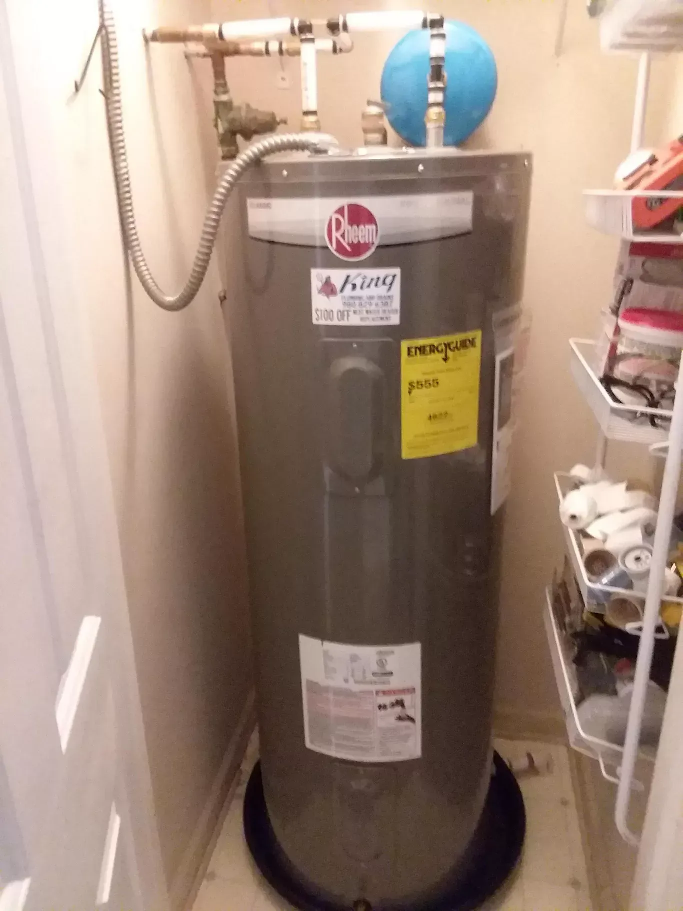An ashley brand water heater is sitting in a closet