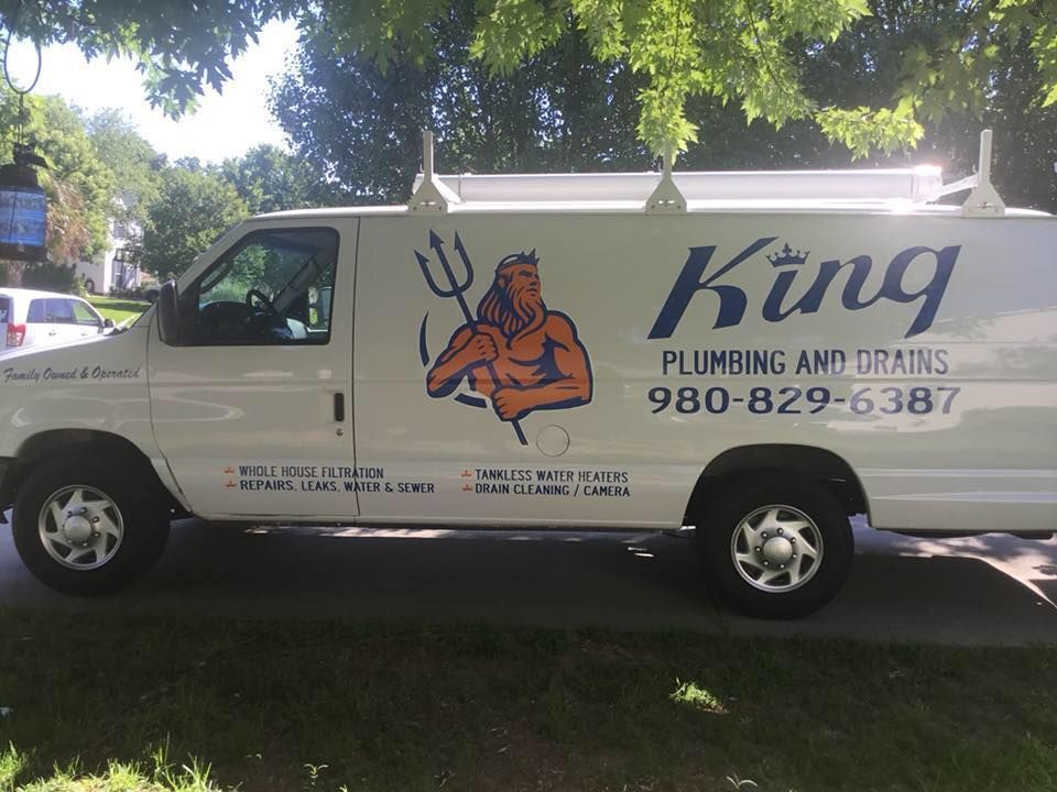 A king plumbing and drains van is parked on the side of the road