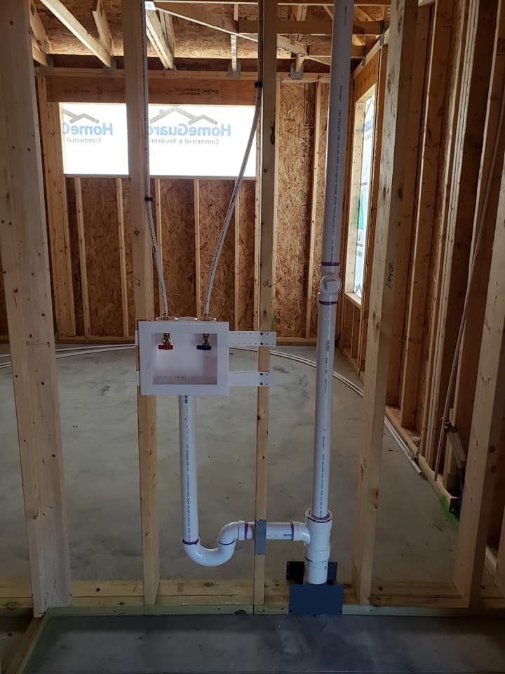 A bathroom sink is being installed in a house under construction.