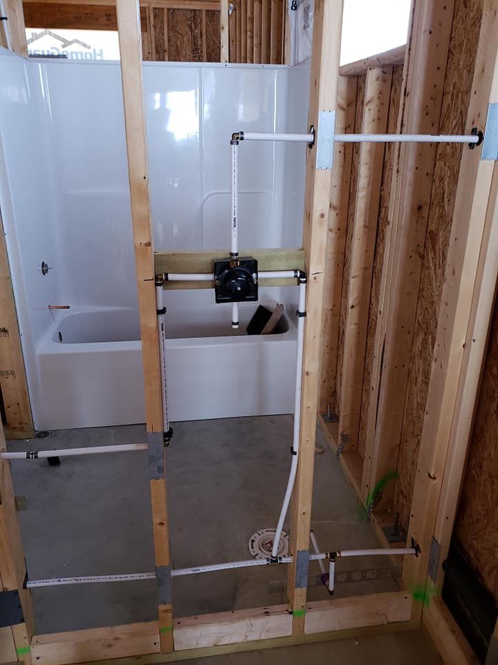 A bathroom under construction with a tub and shower.