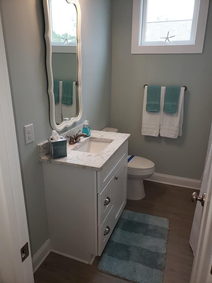 A bathroom with a sink , toilet , and mirror.
