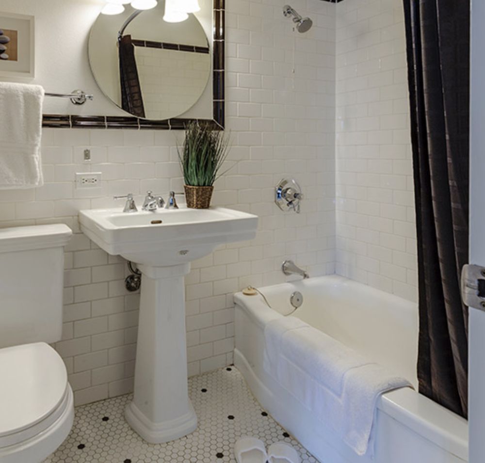 A bathroom with a toilet a sink and a bathtub