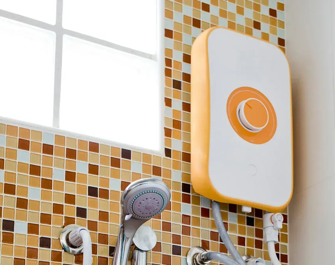 A shower head is attached to a wall next to a window.