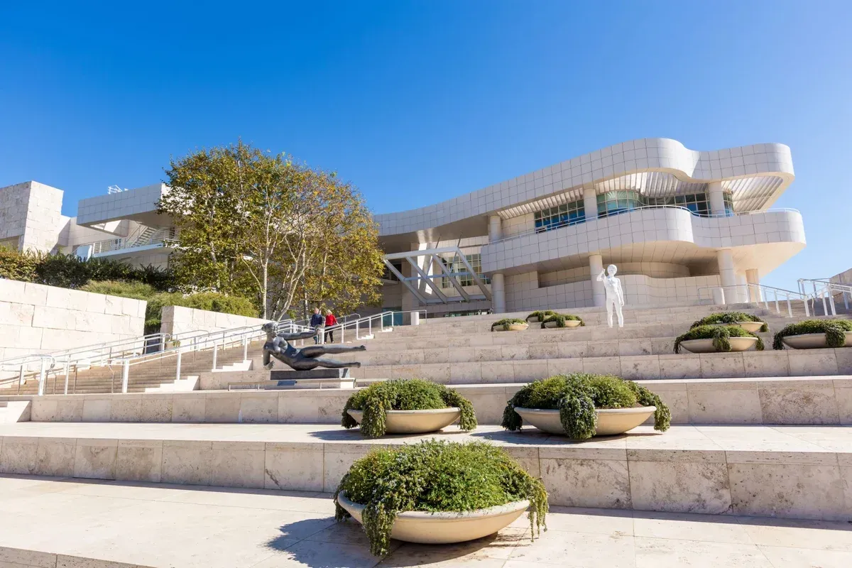 The Getty building with stairs and potted plants in front of it.