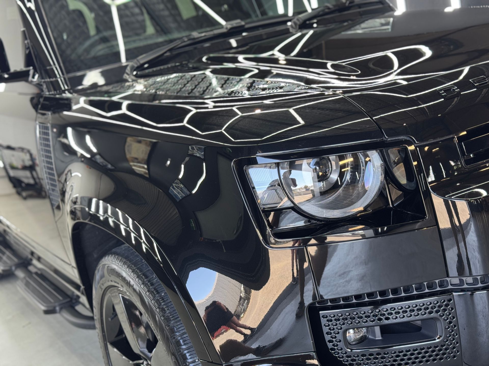 A Man Is Cleaning The Engine Of A Car With A Towel — The Works Auto Salon In East Bendigo, VIC