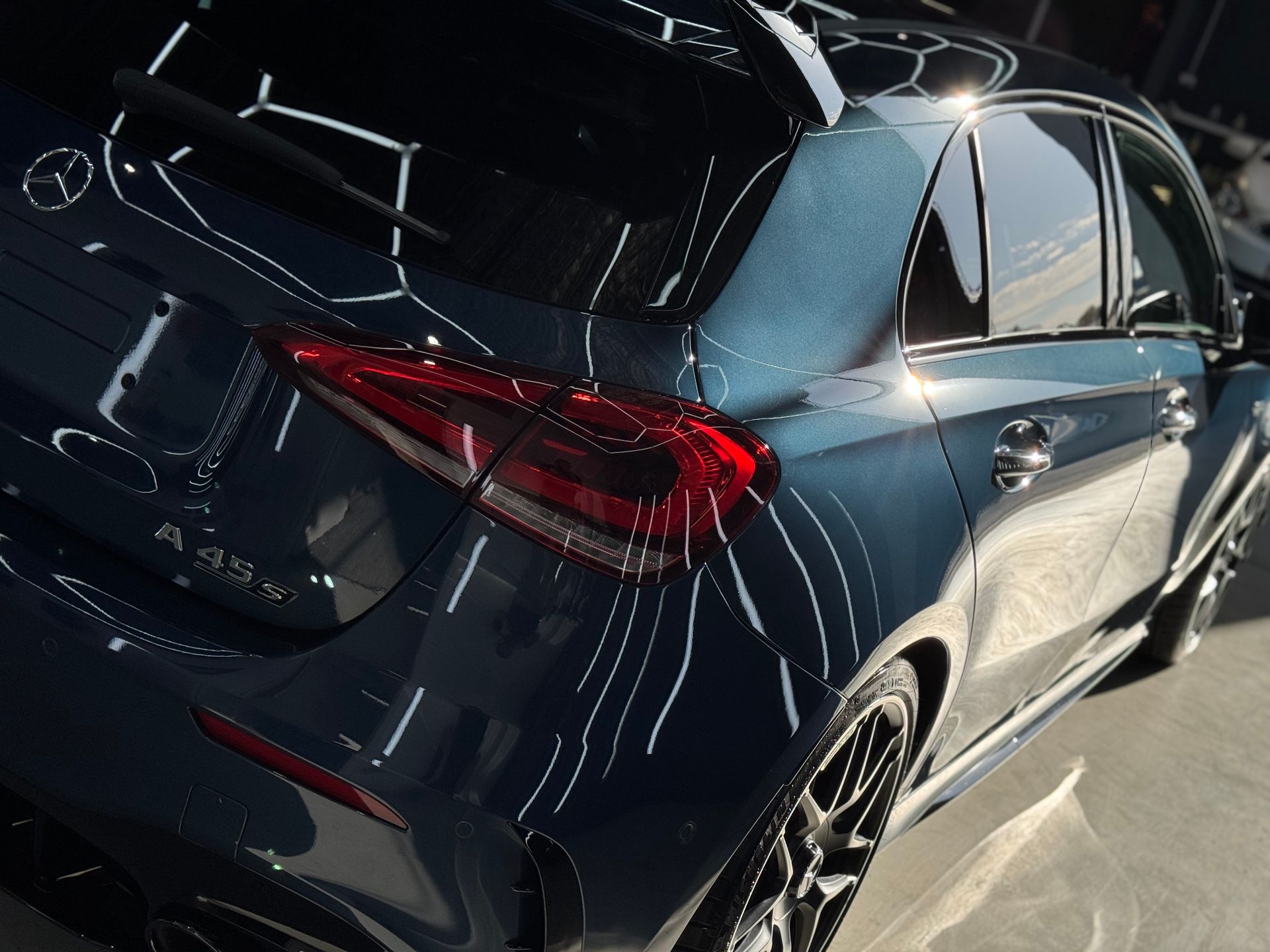 A Man Is Polishing The Fender Of A Car In A Garage — The Works Auto Salon In East Bendigo, VIC