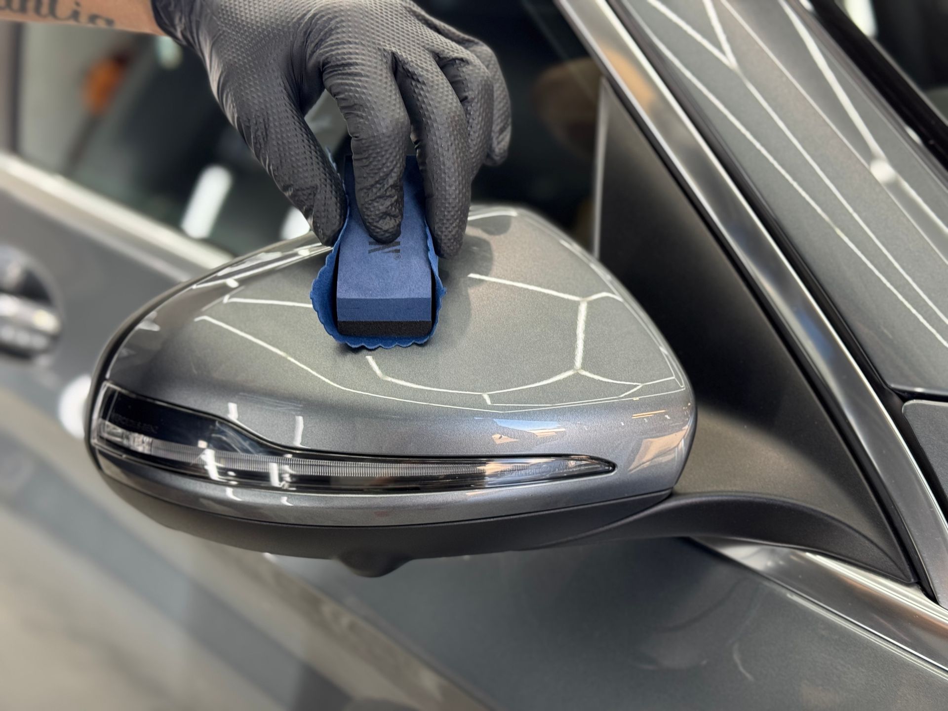 A Person Is Cleaning A Red Sports Car With A Towel — The Works Auto Salon In East Bendigo, VIC